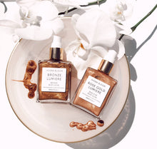 Load image into Gallery viewer, Lucy B's + HYDRA BLOOM - Hydra Bloom Bronze Lumiere Shimmer Oil Body Glow-60ml